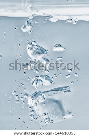 An ice cube falls in the water