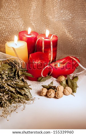 Big candles with nuts and dried flowers