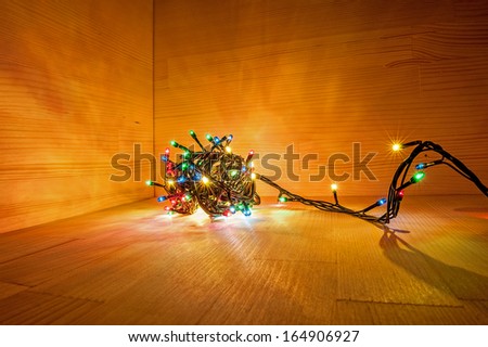 Colorful christmas lights on a wood corner