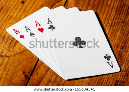 Four ace cards on wood