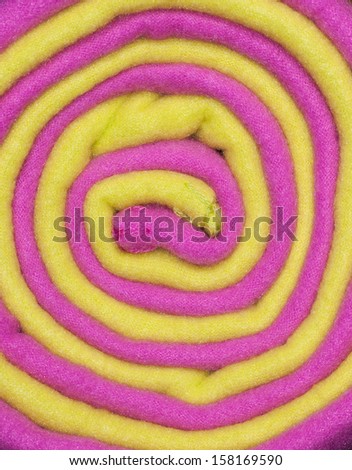 Fleece blankets wrapped in a roll with a colorful abstract pattern