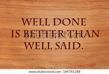Well done is better than well said - motivational quote by Benjamin Franklin on wooden red oak background