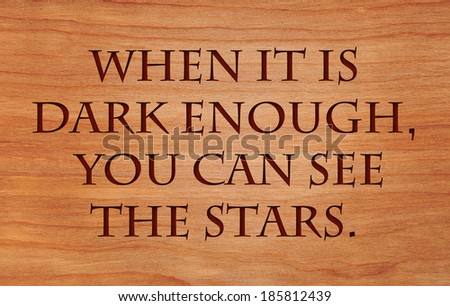 When it is dark enough, you can see the stars. - quote by Ralph Waldo Emerson on wooden red oak background