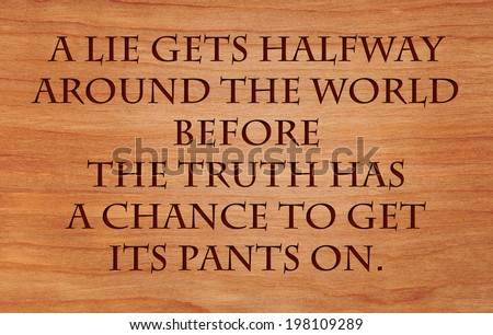 A lie gets halfway around the world before the truth has a chance to get its pants on - quote on wooden red oak background
