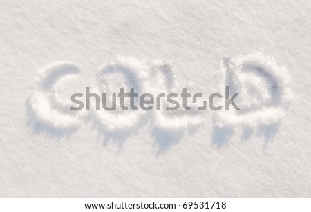 Word cold written in snow, concept of snow proving that the weather is indeed wintry cold