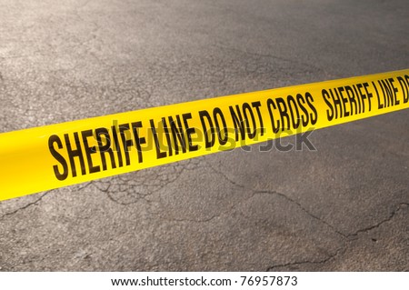 Sheriff line do not cross - caution tape in urban environment