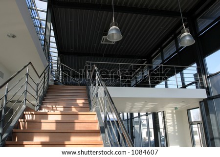 Modern industrial building - steel staircase with wooden finishing.