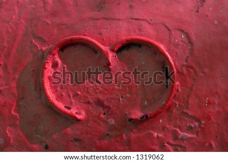 Abstract concrete mooring detail with the number 3 formed out of iron wire and painted all together with a deep red paint