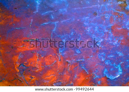 Rusty painted red blue metal plate with paint cracks