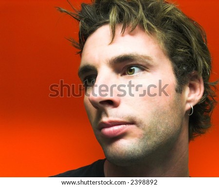 Male model with messy hair, after working and painting. (orange background)-