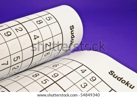 Sudoku puzzle book on purple background