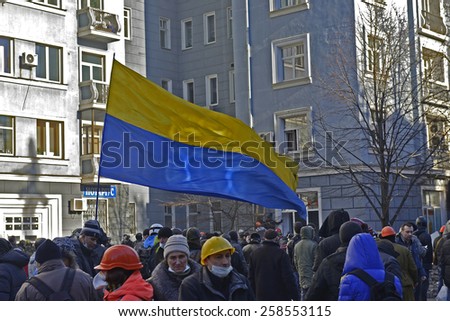 KIEV UKRAINE FEBRUARY 18, 2014: The first day of mass shooting of Euromaydan protesters.The unarmed marchers on Institutska street protects oneself after first attack of armed special forces