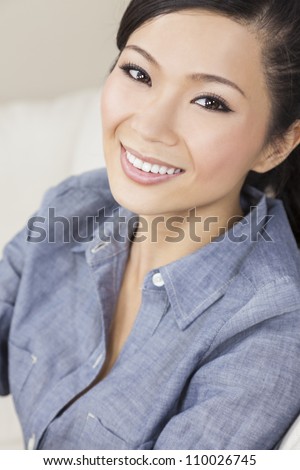 A beautiful young Chinese Asian Oriental woman with a wonderful toothy smile