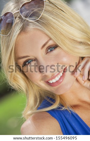Portrait of naturally beautiful woman in her twenties with blond hair and blue eyes & heart shaped sunglasses