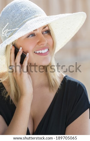 A beautiful girl young female woman with blond hair & blue eyes talking on her cell phone wearing white sun hat and little black dress