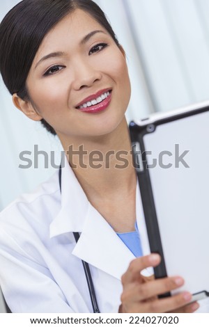 A Chinese Asian female medical doctor using a tablet computer in her hospital office