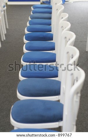 A row of chairs set out and waiting for guests