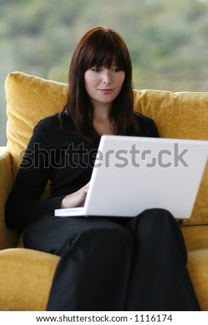 A young woman working at home on her laptop computer.