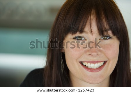 A beautiful young woman with a big smile on her face