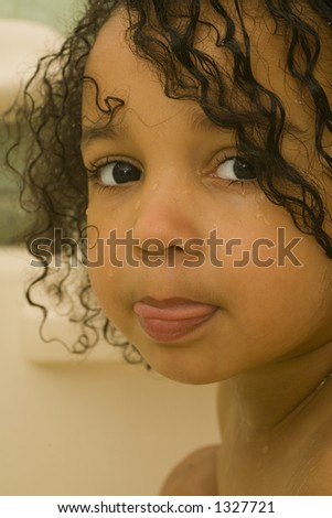A beautiful mixed race girl with wet hair looking at the camera