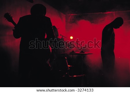 A jazz band shot in silhouette while performing in a club