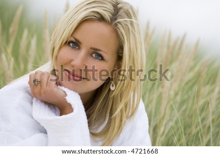 stock photo A beautiful blond haired blue eyed model wearing a white 