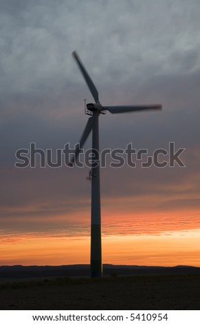 A wind mill shot with slow shutter speed against a beautiful sunset