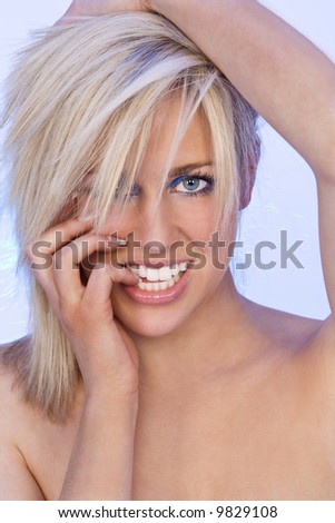 Studio shot of a stunningly beautiful young blond woman shot with blue back lighting