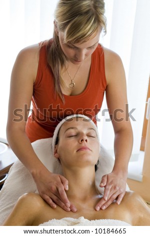 A woman receives a relaxing massage from a beauty therapist