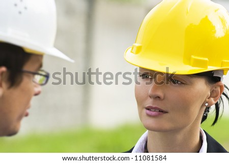 Young male and female managers working together in an industrial situation