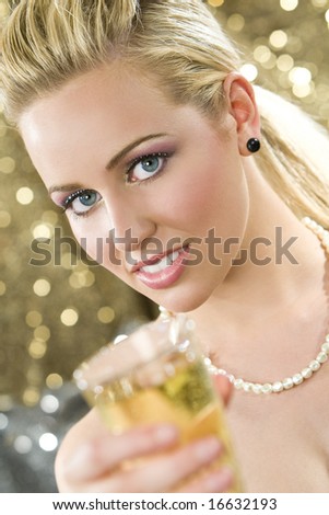 A beautiful young blond haired, blue eyed woman enjoying a glass of champagne