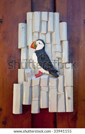A carved wooden puffin sign shot on location in Iceland