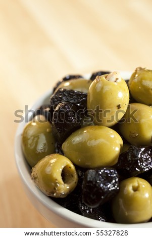 Close up macro photograph of a bowl of stuffed green and black Italian olives