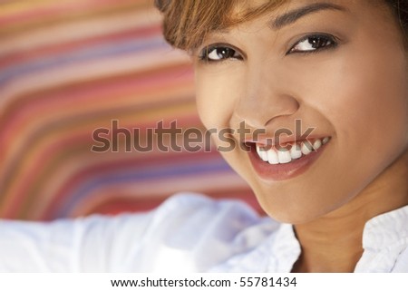 A beautiful mixed race young woman with perfect teeth and smile