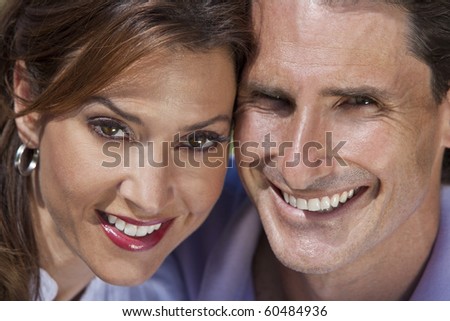Close up portrait shot of an attractive, successful and happy middle aged man and woman couple in their thirties, sitting together outside