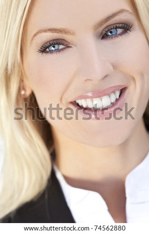 Natural light portrait of a beautiful smiling blond woman with blue eyes