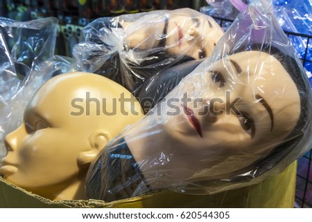 Mannequin shop dummy heads in plastic bags waiting for display