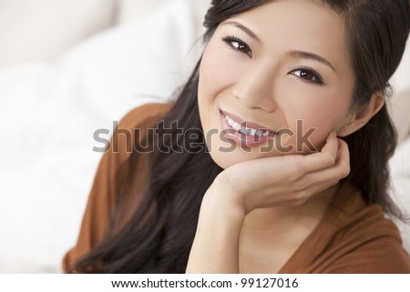 Portrait of a beautiful young Chinese Asian Oriental woman resting on her hand