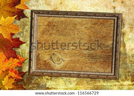 Autumn wooden background with maple leaves and frame Ideal for thanksgiving, holiday or retro designs