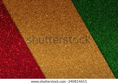 Gold, red and green glitter abstract background with copy space