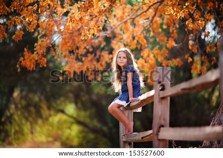Pretty Little Girl Relax At Beauty Autumn Landscape Background