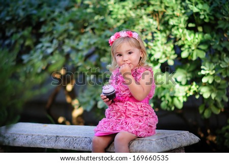 cute fashion little girl eat happy birthday pink cupcake