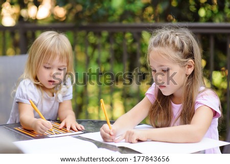 two little kid making school homework outdoor