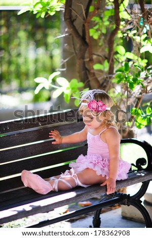 cute little girl ballerina dance at beautiful green nature background