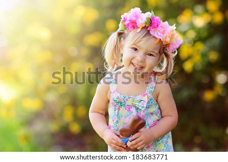cute easter girl with chocolate bunny outdoor