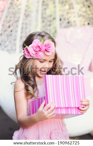 Cute little girl open her birthday gift box