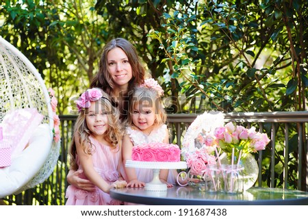 mother and her daughters celebrate family event outdoor in the garden