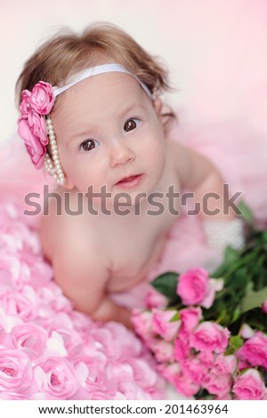Little baby girl with flowers smiling