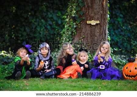Group of kids in costumes on a Halloween party have a fun, trick or treat
