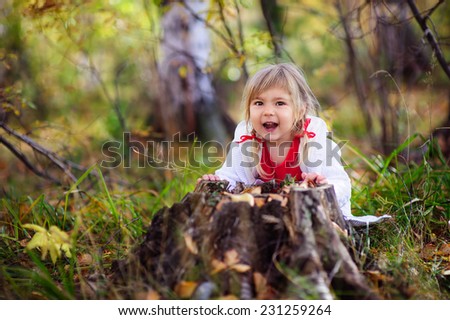 little girl playing peek a boo outdoor
